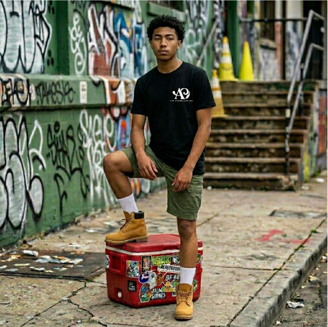 Person standing on a cooler with stickers in an urban setting with graffiti.